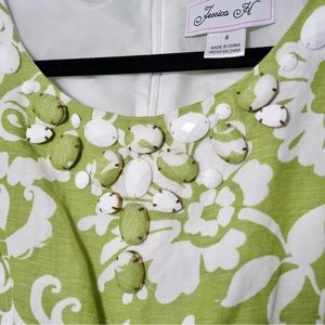Gorgeous green and white floral dress with neckline jewel details and pockets!